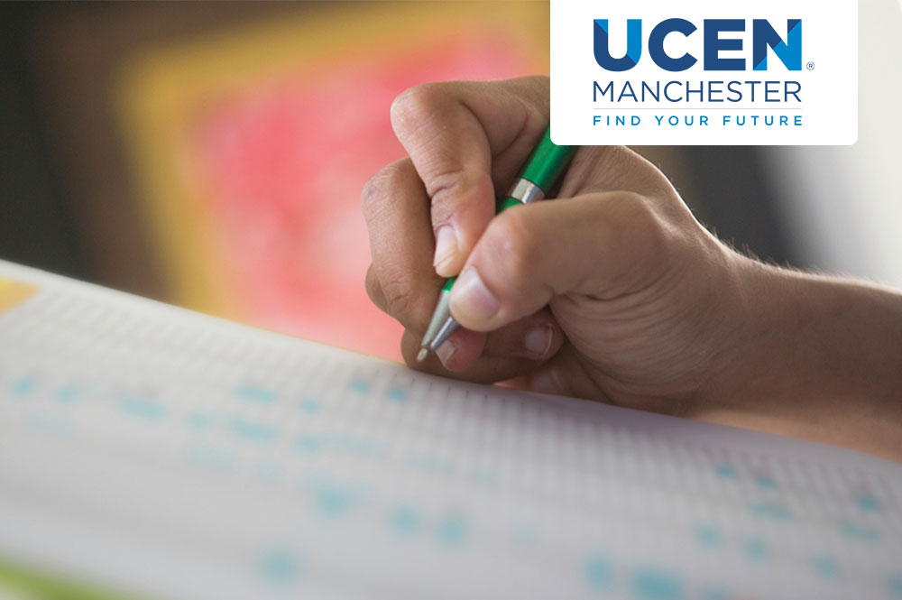Close-up of someone writing in a table