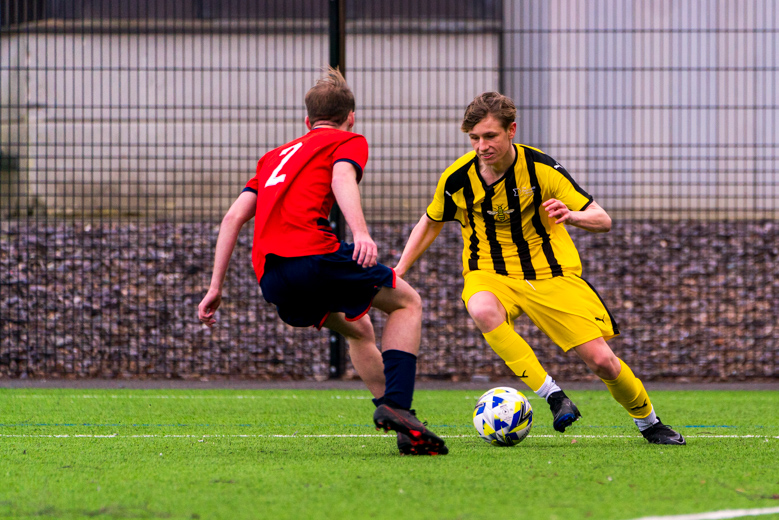Two males playing football