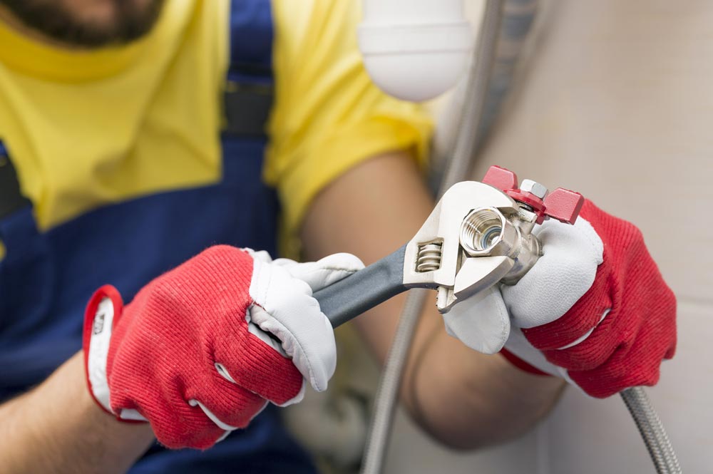 Plumber fixing pipework