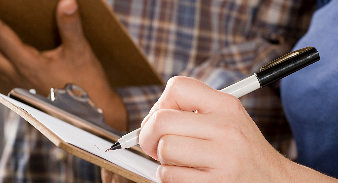 Close-up of someone writing on a notebook