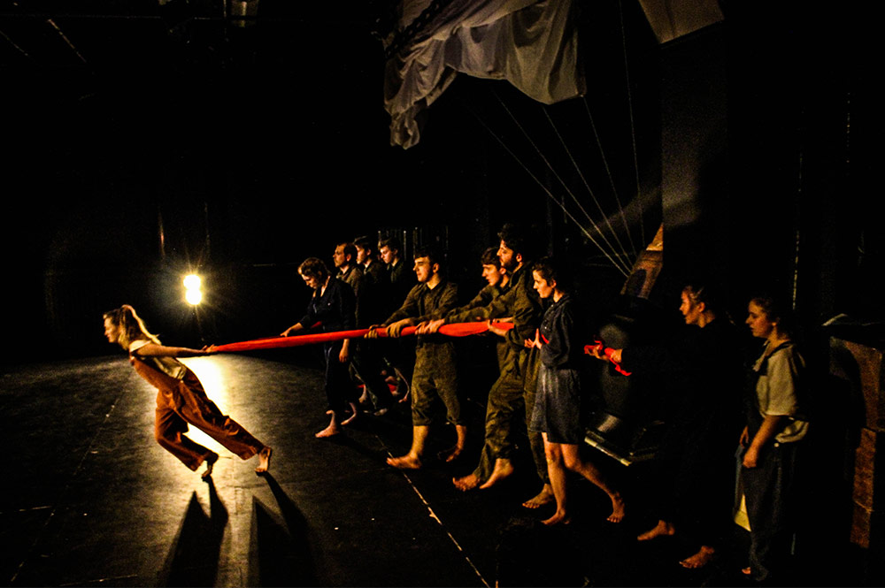Group of students performing a drama live on stage