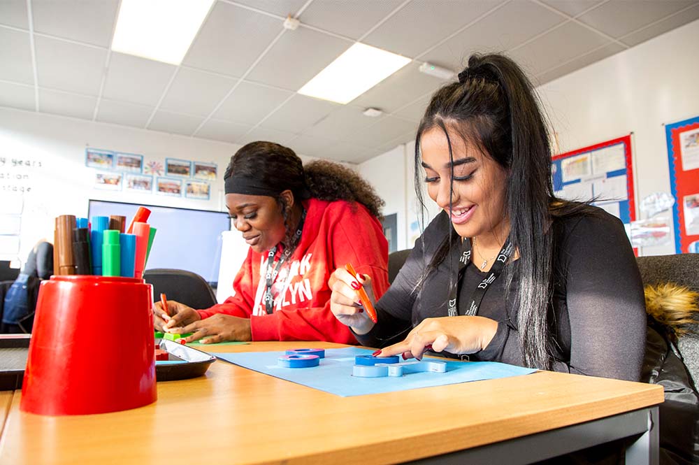 Childcare students creating learning resources