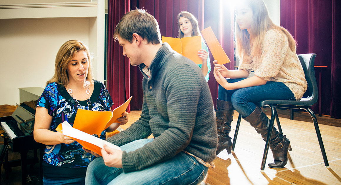 Students rehearsing in class with their tutor