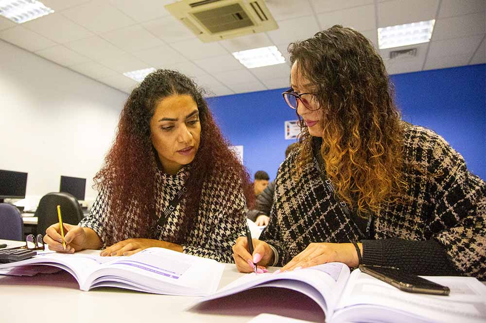 Management students reading a text book
