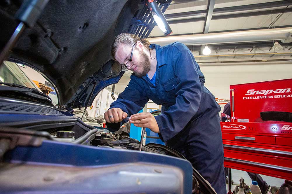 Mechanic looking under the bonnet of a car