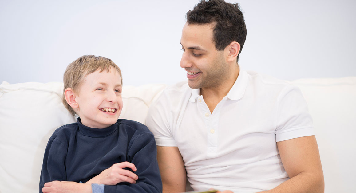 A man laughing with a child