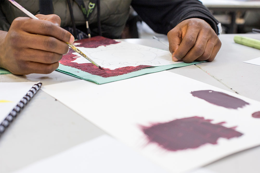 Close-up on an art student creating a piece of work