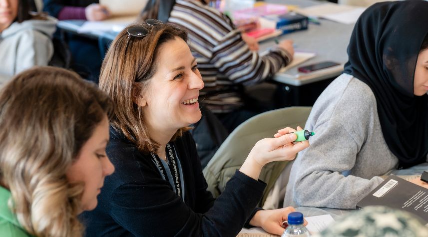 Adult learners taking part in a classroom discussion during an adult education course at The Manchester College.
