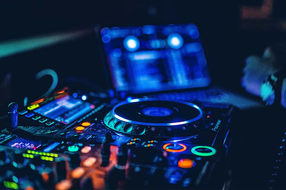 Close-up of a DJ turn-table lit up in the dark