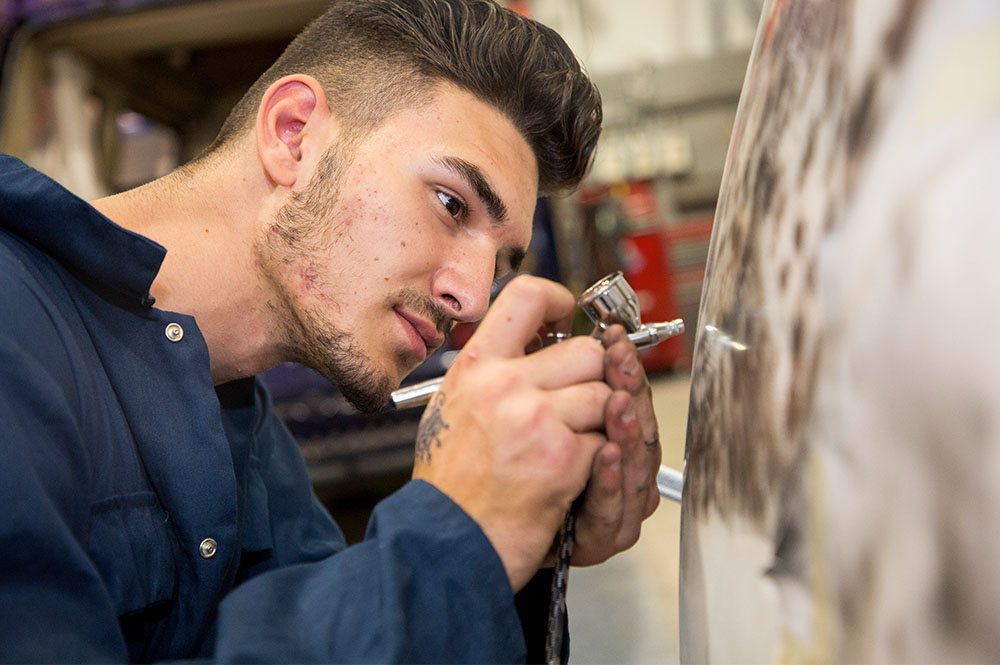 Student doing bodywork on a car