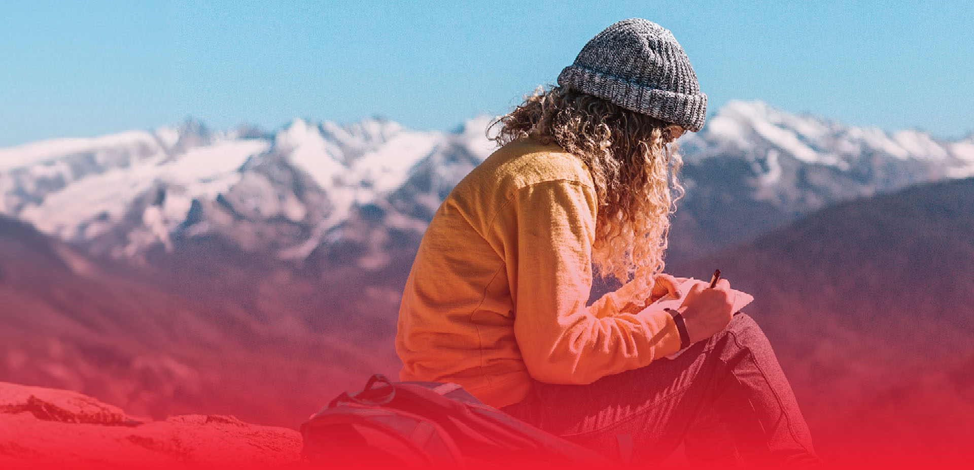 A travller sitting on top of a mountain range