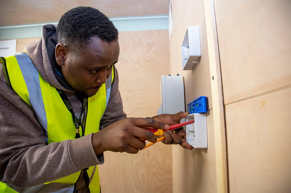 Student electrician wiring in a socket