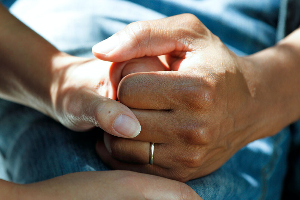Two people holding hands