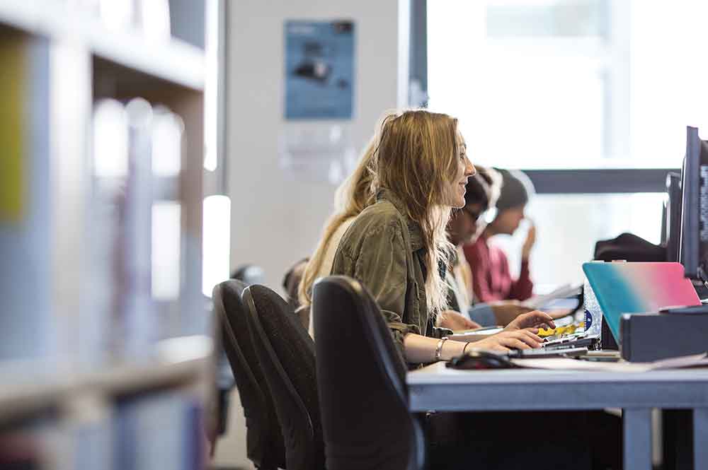 A group of supported internship students studying course material