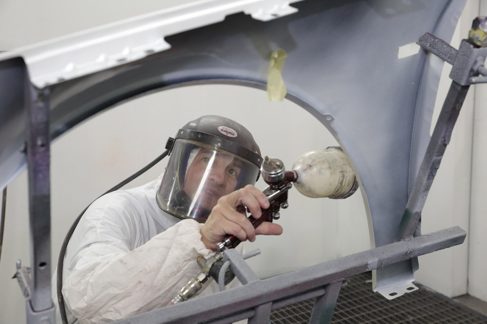 Accident repair mechanic working on a car