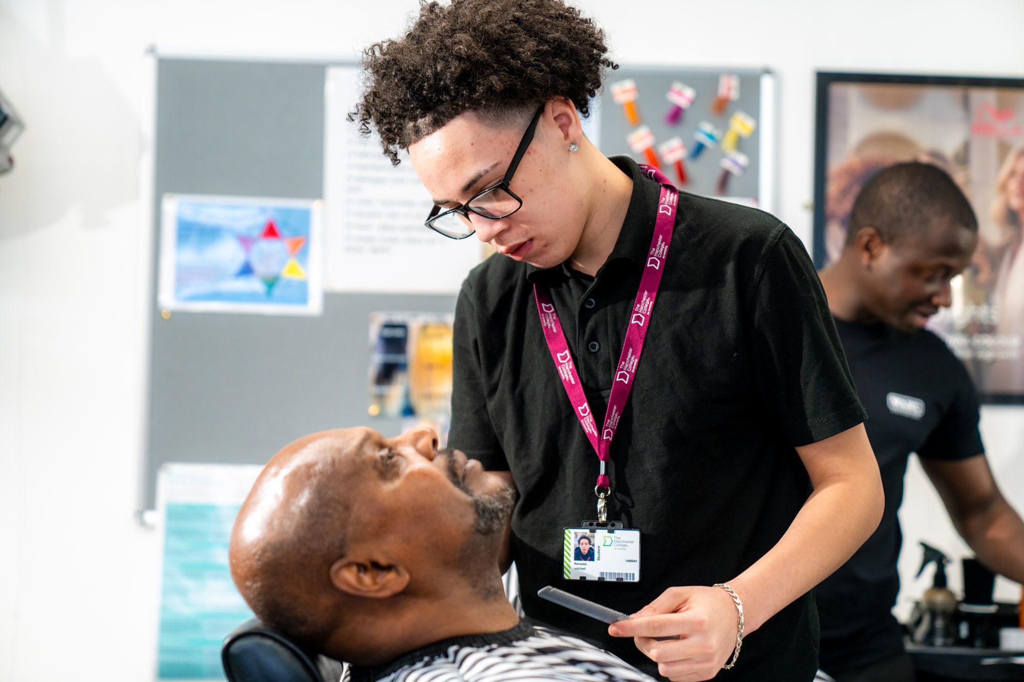 Barbering student with cilent