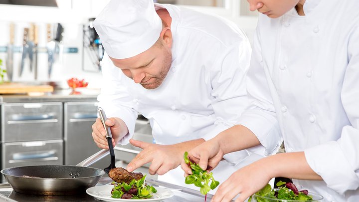 A chef plating up some freshly made food