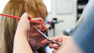 Photograph of a client having their hair cut in a salon at The Manchester College.
