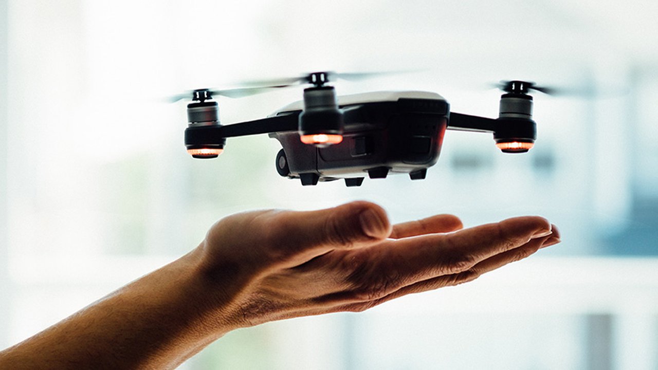 A drone hovering above a pair of hands