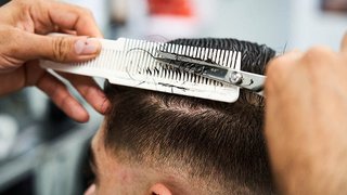 Photograph of a client having their hair cut in a salon at The Manchester College.