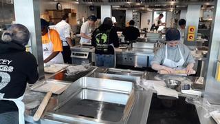 Photograph of prospective students in one of The Manchester College's training kitchens.
