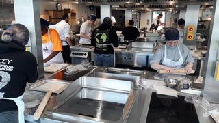 Photograph of prospective students in one of The Manchester College's training kitchens.