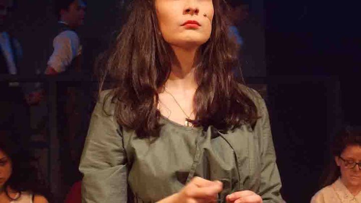 Female student pulling a serious face while performing