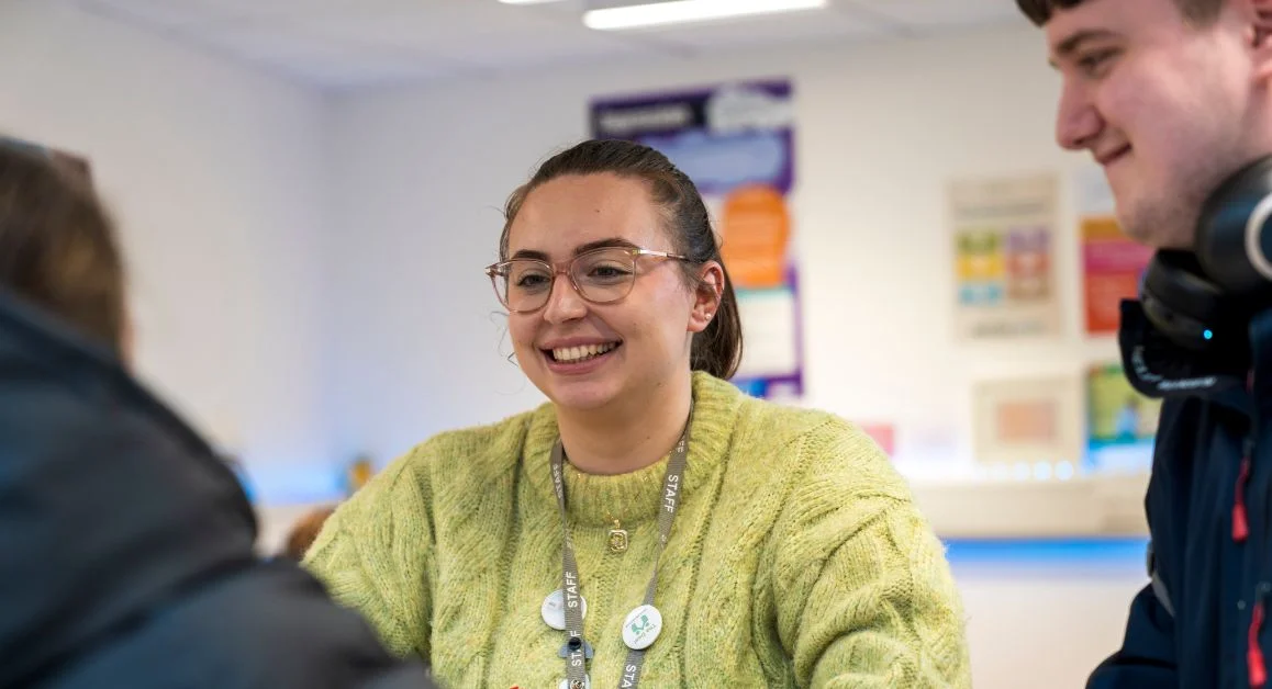 College staff member speaking with students during a careers guidance session at The Manchester College