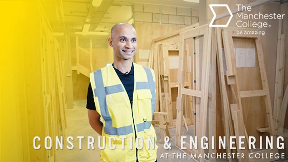 Person wearing a high-visibility vest standing in a construction workshop with timber frames, with text reading “Construction & Engineering at The Manchester College”.