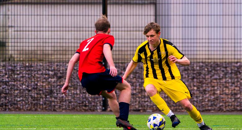 Two males playing football
