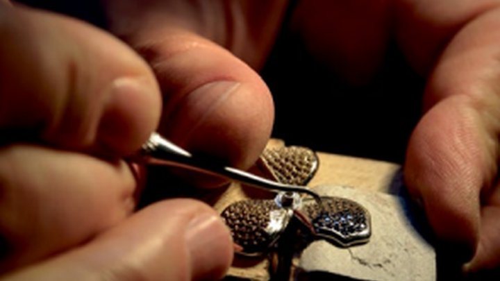 Close-up of someone creating a broach