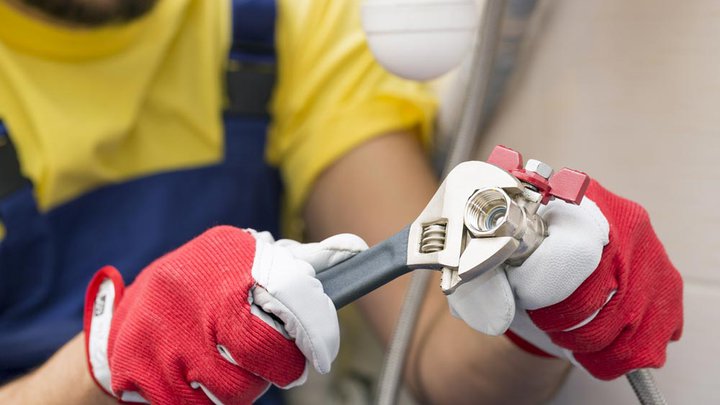 Plumber fixing pipework