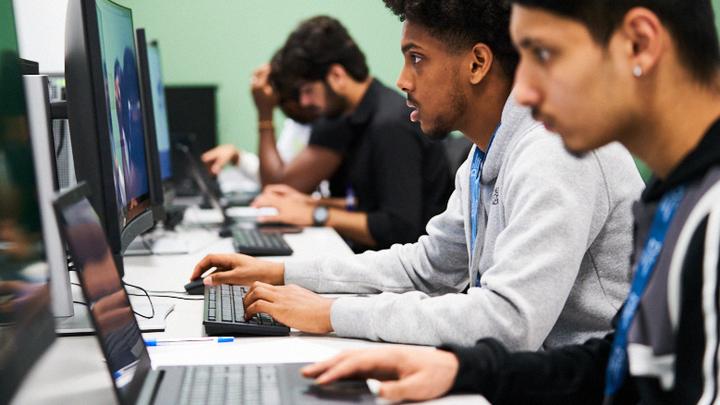 Computing students at their desks