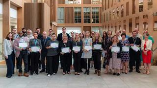 A group shot of The Manchester College colleagues holding their certificates having completed the Leadership of Learning programme.