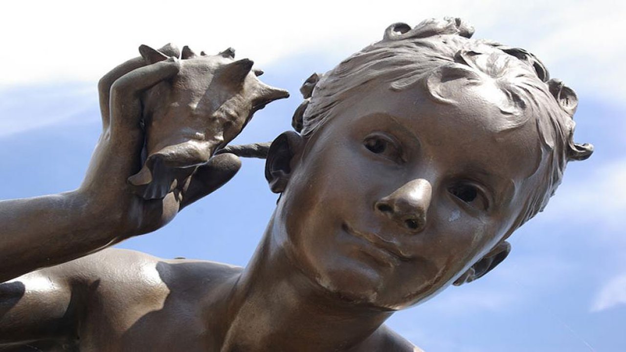 Sculpture of a boy holding a shell