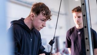 Student using a resistance machine in the gym at The Manchester College's Openshaw Campus.