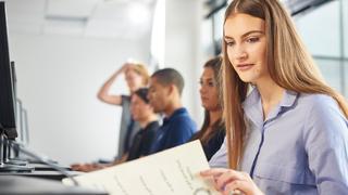 A woman reading a notepad