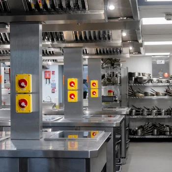 Professional training kitchen at The Manchester College Harpurhey Campus featuring stainless steel workstations, cooking equipment and industry-standard catering facilities.