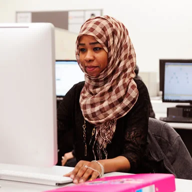 Learner at The Manchester College using a desktop computer in an IT classroom.
