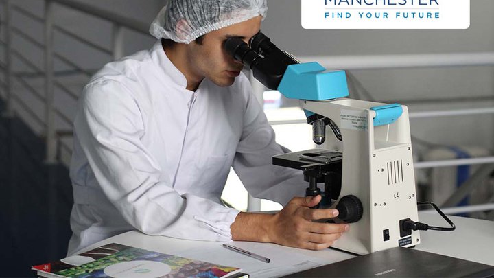 A medical scientist using a microscope