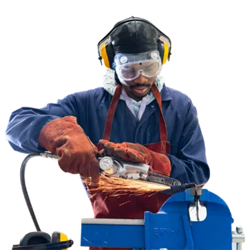 College learner wearing protective goggles, ear defenders and welding gloves, using a power tool on metal, shown as a cut-out image.