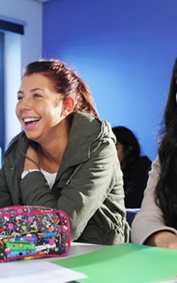 Students laughing and smiling in a classroom