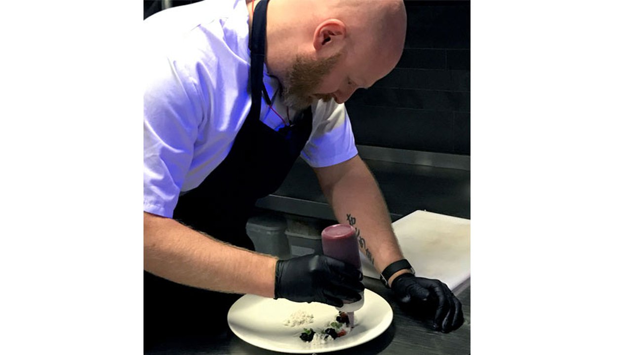 Ian Brooke preparing a meal