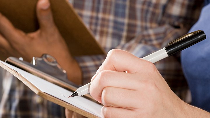 Close-up of someone writing on a notebook