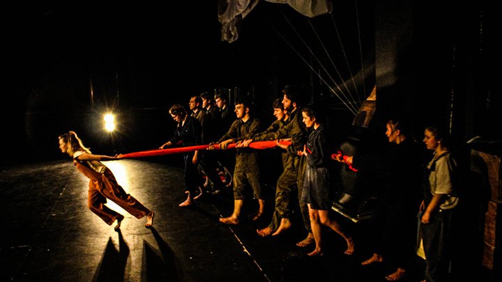 Group of students performing a drama live on stage