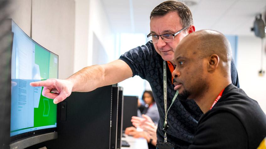 An adult learner engaging during a computing and digital course