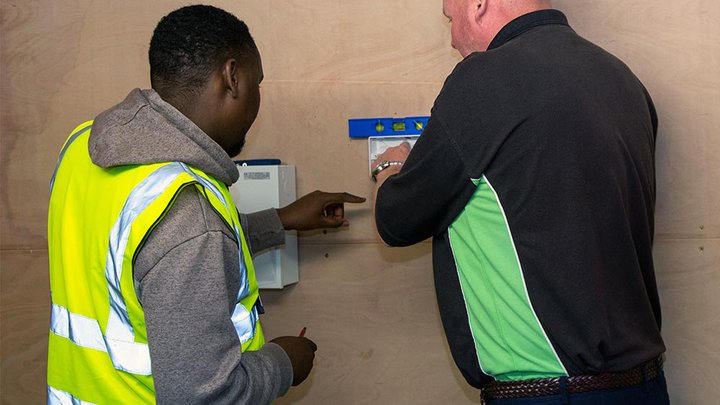 Electrical student and tutor working together