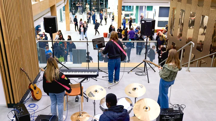 Band performing on the steps at City Campus Manchester