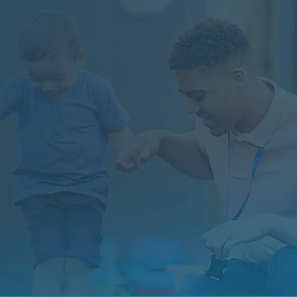 A childcare worker helping a child