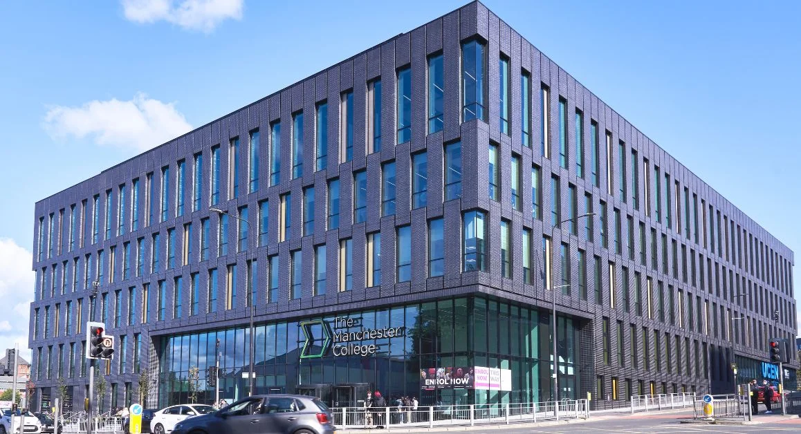 The Manchester College City Centre Campus exterior view with TMC sign above the building doors
